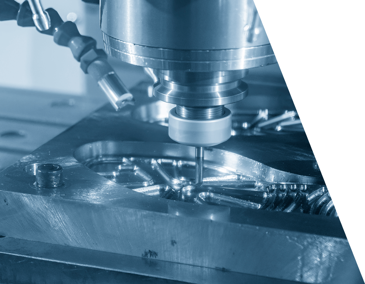 jpeg-optimizer_GettyImages-1407133291 CNC machine operating on a metal workpiece, shaping intricate patterns.